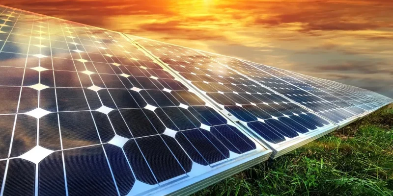 641330a35720b27a54a94f7f_64067211c0a34954ba79a150_solar-panels-on-green-grass-with-a-bright-sun-in-the-background.jpg_11zon_11zon